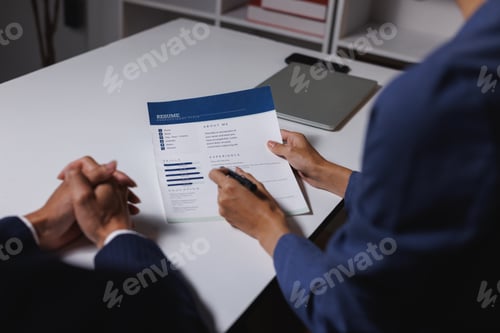 Preview: Recruiter evaluating candidate resume during job interview