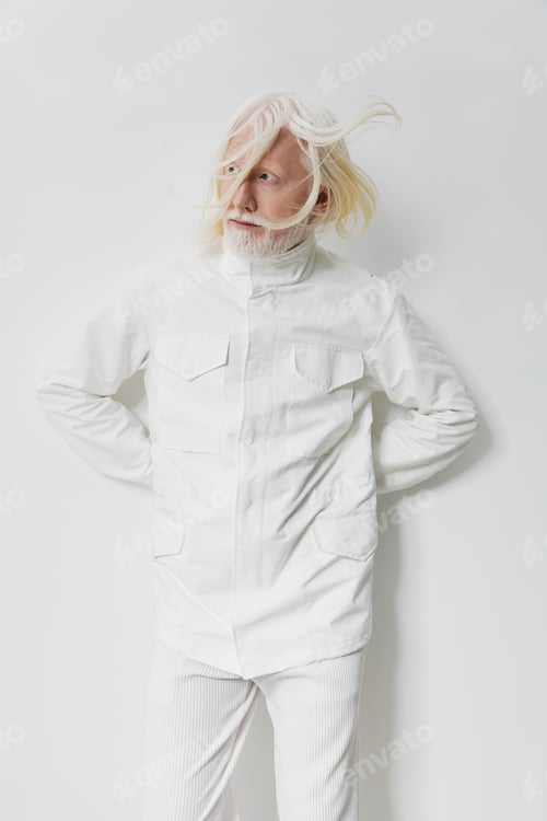 Preview: Fashion model posing in a white outfit with a minimalist background, showcasing a modern aesthetic