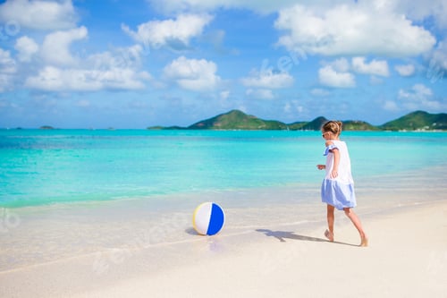 Preview: Adorable little girl playing with ball on beach. Kids summer sport outdoors on caribbean island