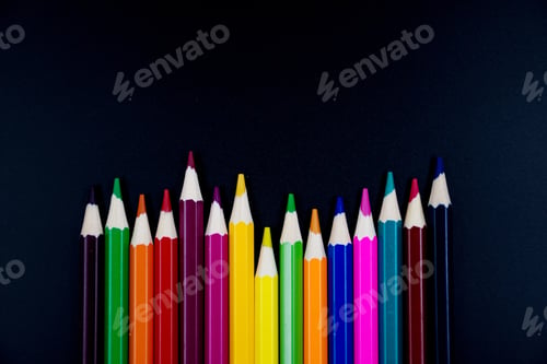 Preview: Back to school. Colored pencils on blackboard background