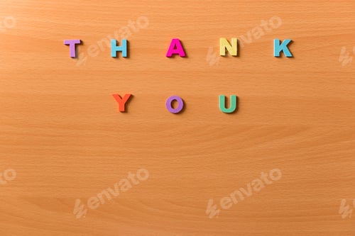 Preview: The words thank you in colored letters on a wooden background