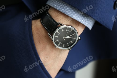 Preview: Businessman in suit with luxury wrist watch, closeup