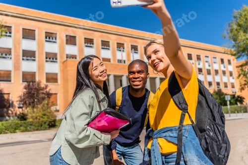 Preview: Happy multi-ethnic students taking selfie outside the university