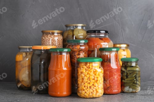 Preview: Jars of tasty pickled vegetables on grey table