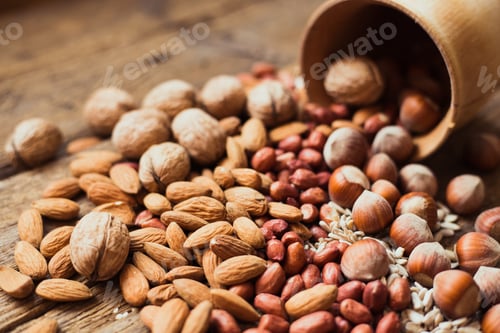 Preview: Wooden Bowl Spilling Walnuts, Almonds, Peanuts, and Hazelnuts