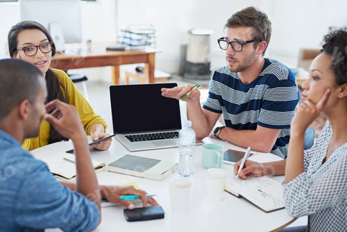 Preview: Developing the software for tomorrow. Shot of a group of young designers at work in an office.