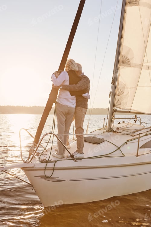 Preview: Only us. Happy senior couple standing on the side of sail boat or yacht deck