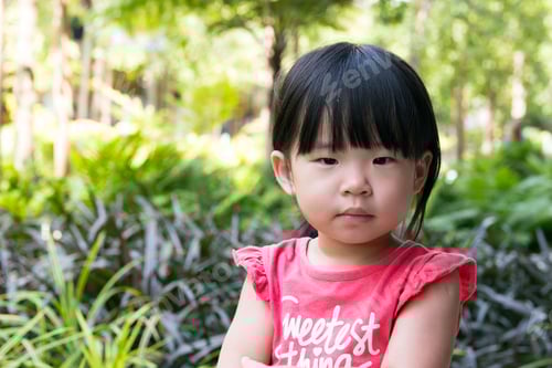 Preview: Young Child with Black Hair Outside in Nature