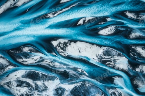 Preview: Abstract blue glacier river delta flowing through rugged landscape in Icelandic Highlands