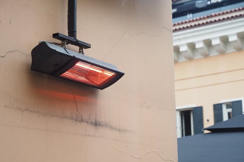 Heating lamp installed on outdoor patio during evening hours