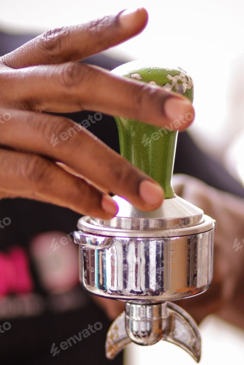 Preview: coffee beans grinds squeezed on the silver coffee maker