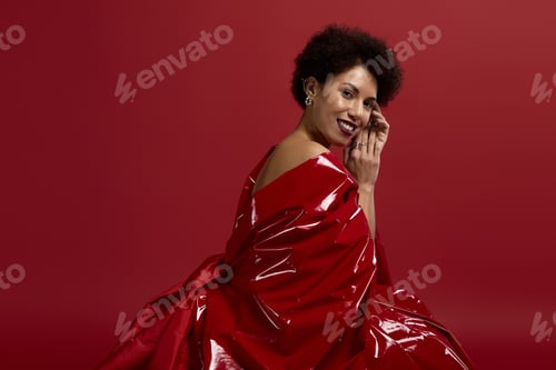 Preview: Elegant woman in vibrant red attire radiates beauty and style in a stunning fashion moment