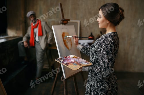 Preview: Female portrait painter and male model in studio