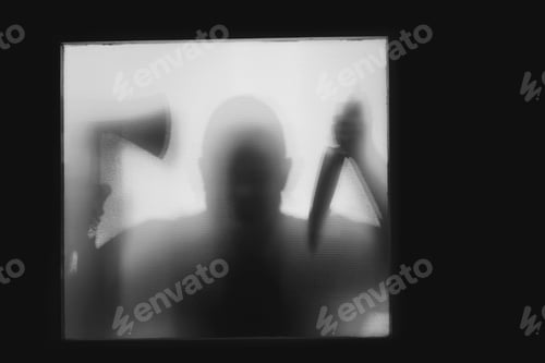 Preview: Man killer with an axe and a knife in his hand. Creepy background