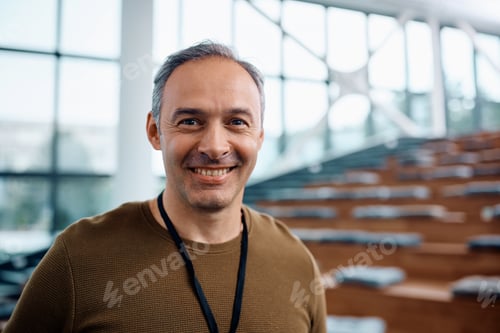 Preview: Happy public speaker during business conference in convention center looking at camera.