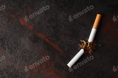 Preview: Concept of smoking addiction, broken cigarette, close-up.