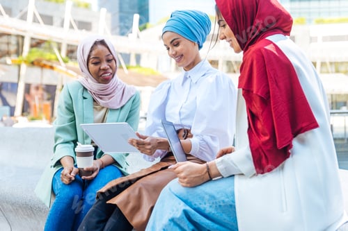 Preview: Beautiful muslim girl wearing hijab bonding outdoors