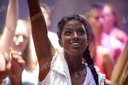 Preview: Letting loose at the club. A pretty young woman partying it up with friends in the club.