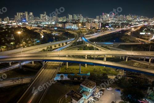 Preview: Aerial view of american highway junction at night with fast driving vehicles in Miami, Florida.