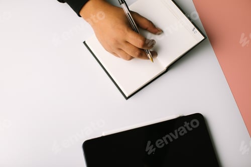 Preview: Hand writing in a blank notebook