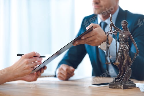 Preview: cropped shot of lawyer holding clipboard and client signing document