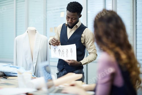 Preview: Confident black designer presenting his clothing collection