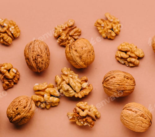 Preview: Walnuts in shell and peeled are lying on a brown background