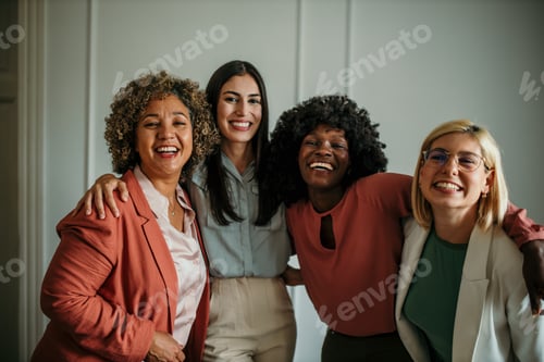 Preview: Four businesswomen smiling and embracing each other in office environment
