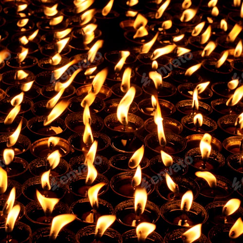 Preview: Butter lamps with flames near Bodhnath stupa in Kathmandu, Nepal