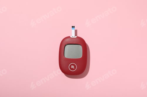 Preview: Red glucometer on pink background, top view