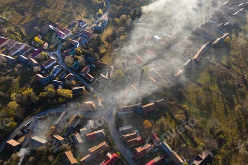 Preview: Aerial drone view of morning haze and mist above village houses. Manastireni, Romania