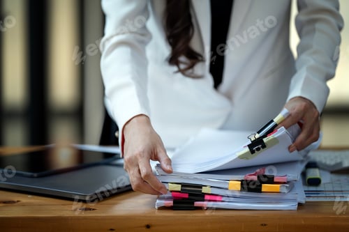 Preview: woman hands working on Stacks paper files for checking document achieves on folders papers.