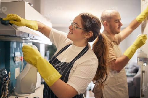 Preview: Saturdays are for spring cleaning together. Shot of a young couple cleaning their kitchen together.