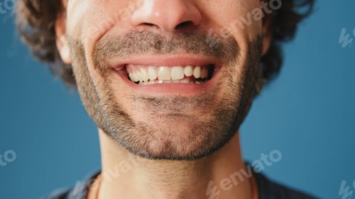 Preview: Detailed close-up shot of man's smile in studio on blue background