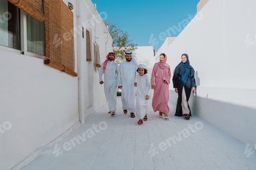 Preview: Arab family walking together smiling on white street