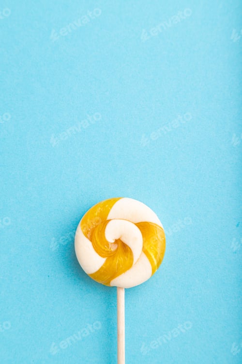 Preview: Single lollipop candy on blue background. copy space, top view