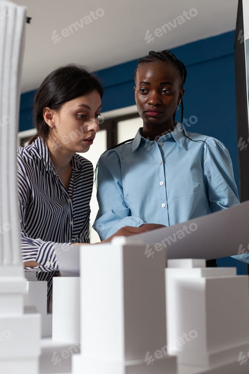 Preview: Multi ethnic work team looking at building model