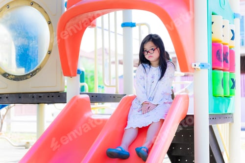Preview: Asian child girl wearing glasses was bored at slider.
