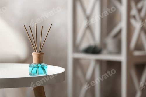 Preview: Reed air freshener on white table indoors, space for text