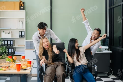 Preview: Young Asian Professionals Celebrating with Pizza and Drinks