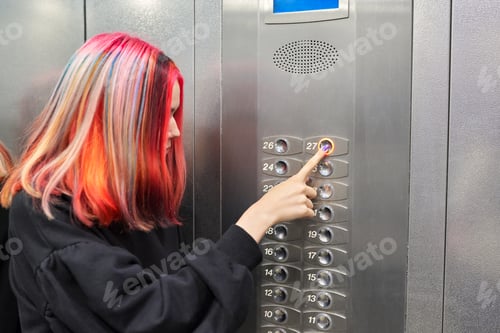 Preview: Female teenager pushing a button in the elevator