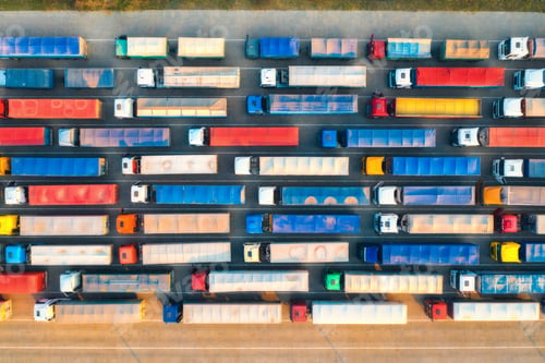 Preview: Aerial view of colorful trucks in terminal at sunset in summer