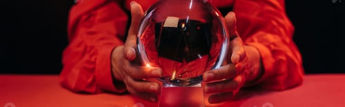 Preview: selective focus of crystal ball near cropped fortune teller isolated on black, banner