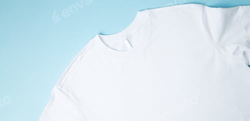 Preview: Basic folded white t-shirt blue background. Mock up for branding t-shirt. Copy space