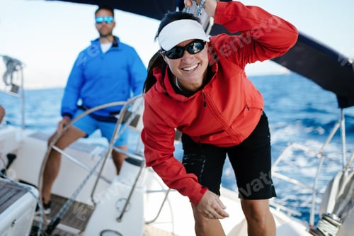 Preview: Attractive strong woman sailing with her boat