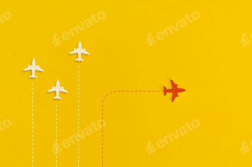Preview: Toy airplanes on a yellow background. Leadership and new idea concept.