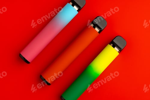 Preview: Disposable electronic cigarettes on red background close up