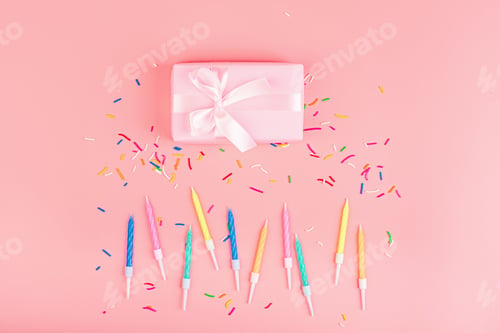 Preview: Happy birthday flatlay: gift box and candles on pink background