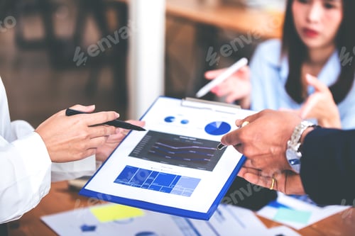 Preview: Team work with business analytic price chart on the table at the conference room.