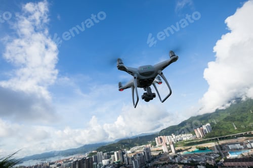 Preview: White drone with camera flying in the air